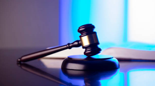 Gavel, Themis sculpture and law code in lawyers office. Bluelight background.